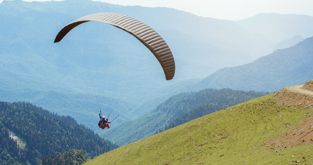 Skydiving sport. Paraglider fly from the beautiful mountains