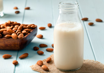 Almond Milk and nuts in a wooden bowl