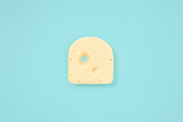 Piece of cheese on blue color background