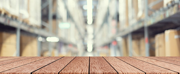 abstract blur background of inside corridor industry cargo with brown wood table perspective for...