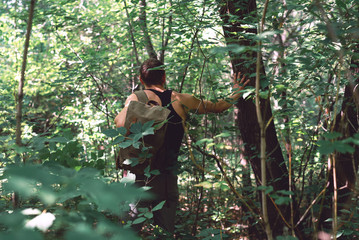 Man stray in a forest and is trying to find out exit.