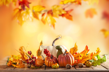 Autumn background from fallen leaves and pumpkins on wooden vintage table. Autumn concept with...