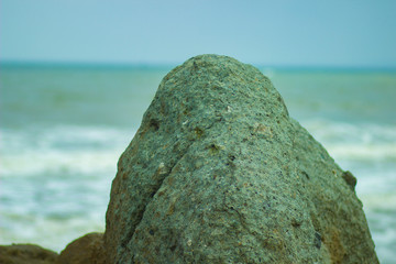 Large rocks and strong waves on the picturesque shore of the warm Pacific ocean