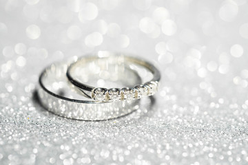 Gold wedding rings. Glitter background