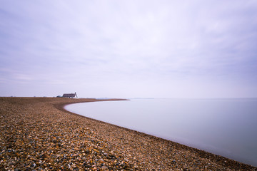 A long exposure of the clouds and water at Shingle Street in Suffolk. The water has taken on a milky effect and there is lots of negative space