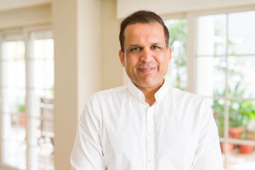 Naklejka premium Middle age man smiling confident to the camera at home