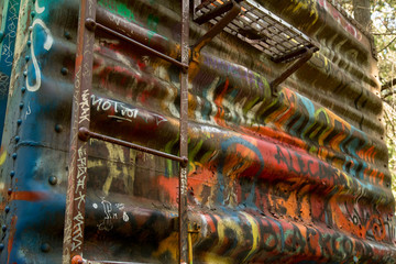 Abandoned wreck Train Car Graffiti in forest 02