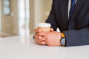 Close up of middle age man holding cup of coffee
