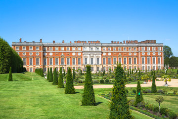 London, UK. English garden view and the East Front of Hampton court 17th century locates West London