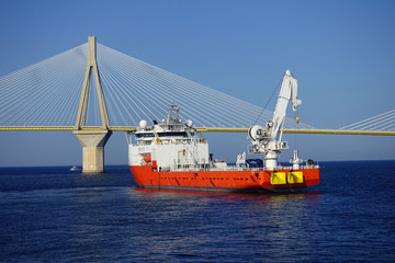 Naklejka premium Repair vessel in modern anti seismic cable bridge of Rio Antirio Harilaos Trikoupis that connects Peloponnese to mainland Greece