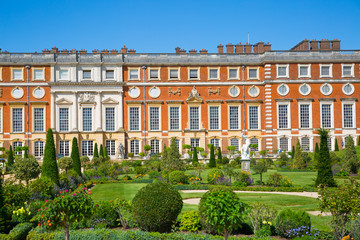 London, UK. English garden view and the East Front of Hampton court 17th century locates West London