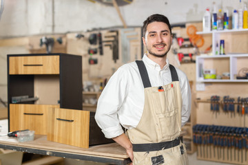 furniture factory, Small-Sized Companies and people concept - Portrait of a smiling male worker at manufacturing