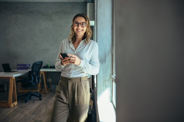 Smiling businesswoman at work in office