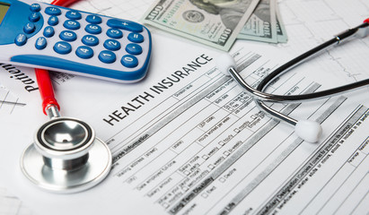 Health insurance application form with banknote and stethoscope concept for life planning.