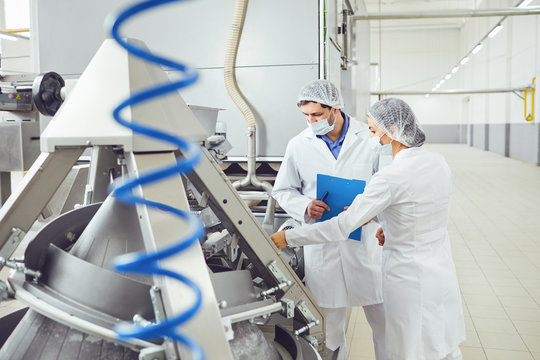 Technologists Inspector In Masks At Food Factory.