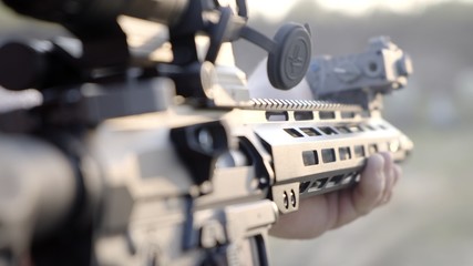 Fototapeta na wymiar A man shoots a modern rifle. Close up