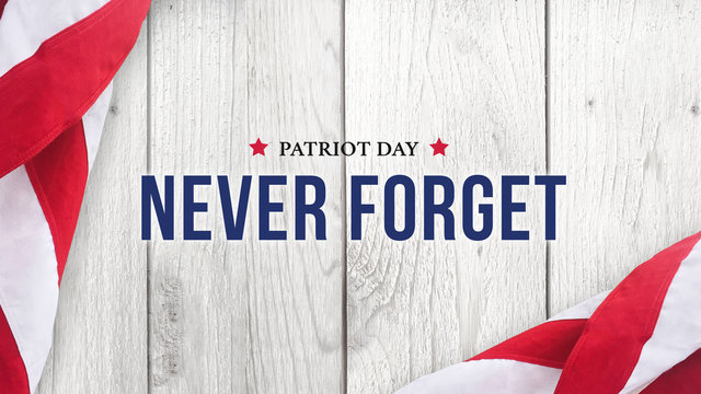 Never Forget - Patriot Day Text Over White Wood with Flags