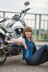 Fototapeta na wymiar Fashion sexy woman is sitting near classic style cruiser motorbike. Girl biker with perfect fit slim body on highway. The spirit of freedom and independence. 