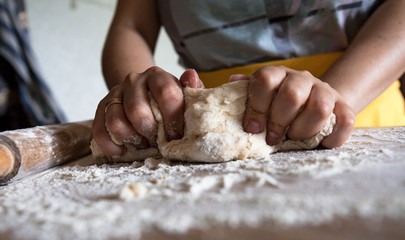 Female hands making dough at home