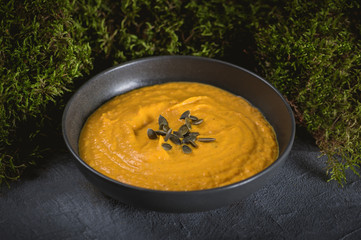 Pumpkin cream soup with cream and pumpkin seeds