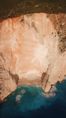 Aerial drone view of iconic beach of Navagio or Shipwreck voted one of the most beautiful beaches in the world with deep turquoise clear sea, Zakynthos island, Ionian, Greece