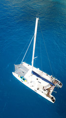 Aerial drone top view photo of Catamaran boat docked in popular Ionian island destination, Greece