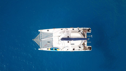Aerial drone top view photo of Catamaran boat docked in popular Ionian island destination, Greece