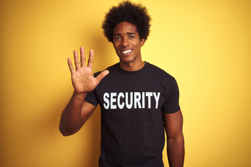 American safeguard man with afro hair wearing security uniform over isolated yellow background...