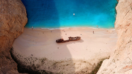 Aerial drone view of iconic beach of Navagio or Shipwreck voted one of the most beautiful beaches in the world with deep turquoise clear sea, Zakynthos island, Ionian, Greece