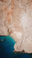 Aerial drone view of iconic beach of Navagio or Shipwreck voted one of the most beautiful beaches in the world with deep turquoise clear sea, Zakynthos island, Ionian, Greece