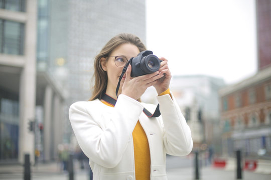 Girl taking photos in the street