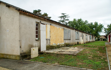 Fototapeta na wymiar Disused and abandoned historic military buildings at CAFI Sainte-Livrade, France, serving in the past to house French repatriates from Indochina since 1956.