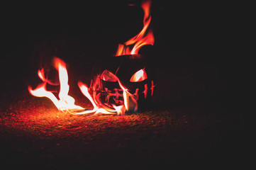 green watermelon burns with fiery flame on the scary holiday of october halloween