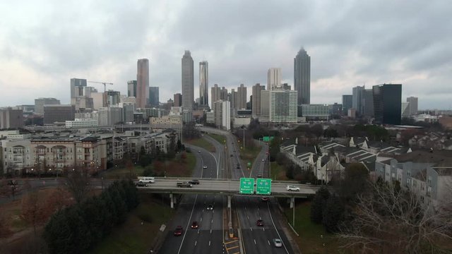 Aerial: Cars Drive Along a Highway To and From Downtown Atlanta at Dusk