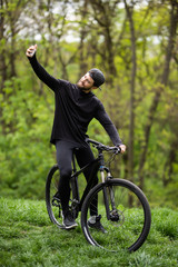 Cyclists man taking selfie next bike on top of a mountain