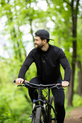 Mountain biker riding on bike in spring inspirational mountains landscape. Sport fitness motivation and inspiration. Rider mountain biking in fall woods.