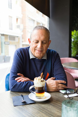 Handsome middle age senior man drinking coffee at restaurante, smiling happy enjoying and relaxing retirement