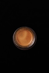 Cup of espresso on black background. Top view. Copy space. 
