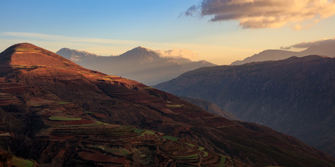 Obraz premium Dongchuan Red Earth Multi-Colored Terraces - Red Soil, Green Grass, Layered Terraces in Yunnan Province, China. Chinese Countryside, Agriculture, Exotic Unique Landscape. Farmland, Agriculture