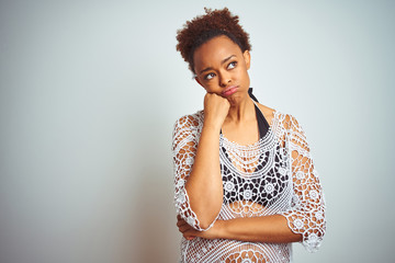 Young african american woman with afro hair wearing a bikini over white isolated background thinking looking tired and bored with depression problems with crossed arms.