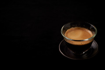 Cup of espresso on black background. Copy space. 