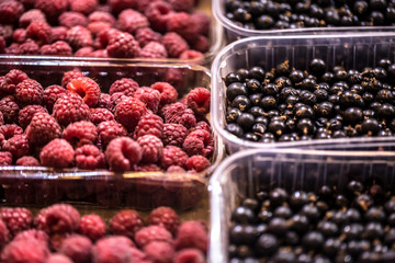 Display of fresh raspberries and berries at the weekend farmer's market