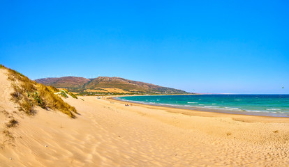 Fototapeta na wymiar Punta Paloma beach, a unspoiled white sand beach of The Nature Park del Estrecho. View from the Dune of Valdevaqueros. Valdevaqueros inlet. Tarifa, Cadiz. Andalusia, Spain.