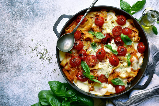 Pasta Casserole With Tomatoes And Mozzarella Cheese. Top View With Copy Space.