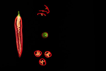 Seamless pattern with red hot chili peppers. Vegetables abstract background. Food collage, slicing hot red chili peppers Red hot chili peppers on a black background.