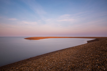 A long exposure of the clouds and water at Shingle Street in Suffolk. The water has taken on a milky effect and there is lots of negative space