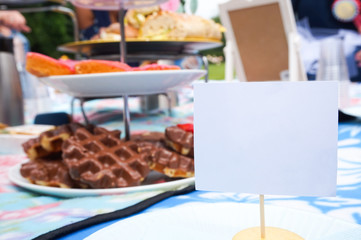 Place card for a guest at a tea party picnic for a bridal shower. Room for copy on the standing name tag, as table decor.
