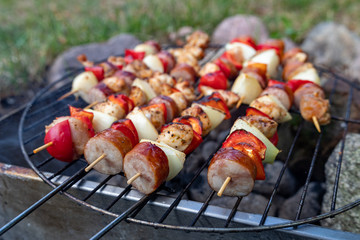 Tasty skewers prepared on the grill. A tasty meal outdoors in the home garden.