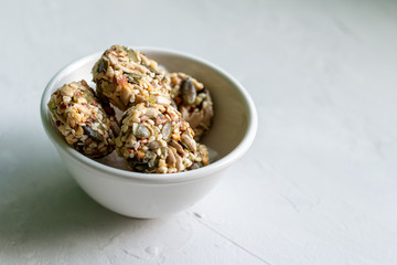 Homemade sweets energy balls made from superfoods like seeds, nuts and dried fruits. Healthy snack, raw dessert and superfood. With space for text