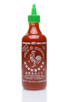 IRVINE, CALIFORNIA - JULY 14, 2014: A bottle Sriracha Hot Chili Sauce. From Huy Fong Foods the company has been accused by neighbors of ruining their air quality with emissions from its chili processi